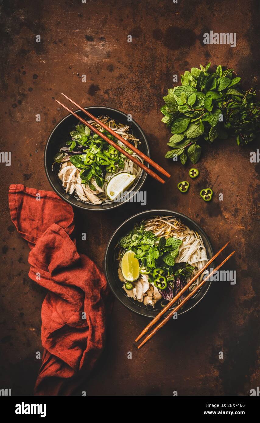 Vietnamese asian traditional rice noodle and chicken soup in bowls