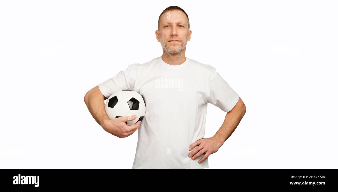 Man with soccer ball in akimbo posing standing against white background Stock Photo