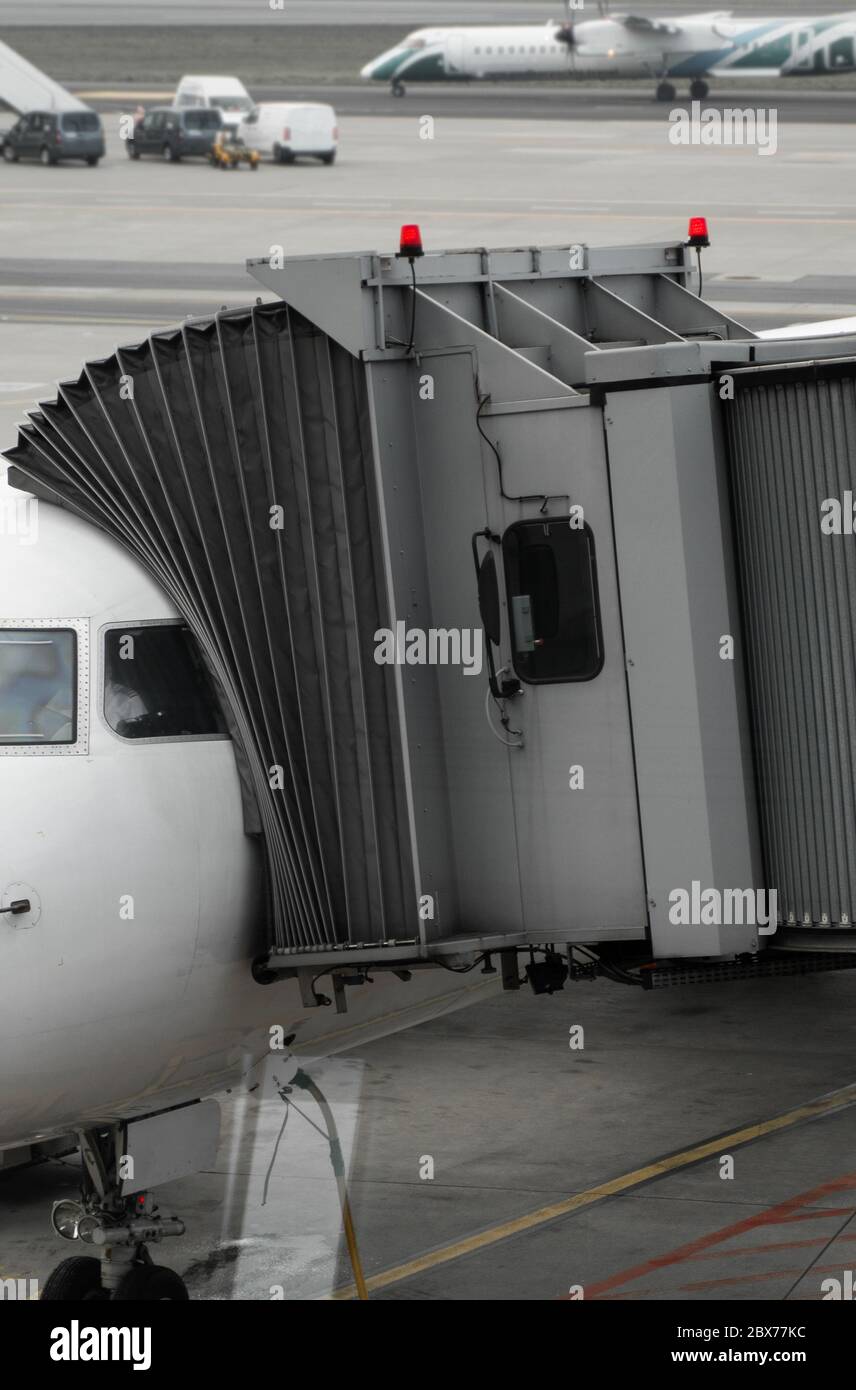 Plane on airport connected to gate sleeve. Aircraft and sleeve. Gate at