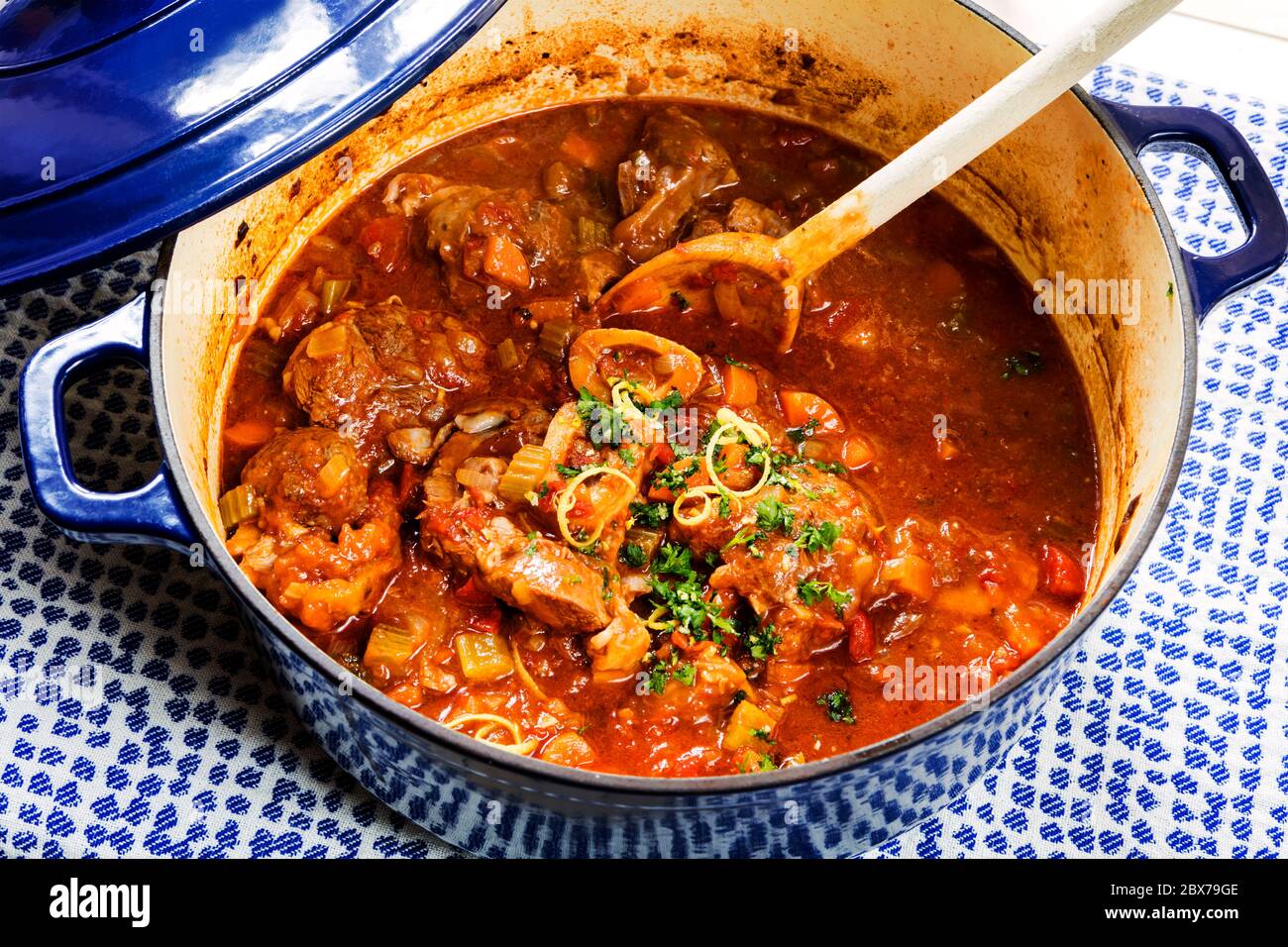 Osso buco alla Milanese in heavy crock pot, topped with gremolata