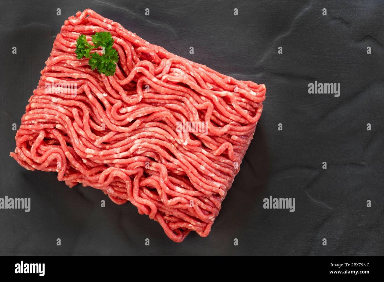 Raw ground beef, top view, on slate. Stock Photo