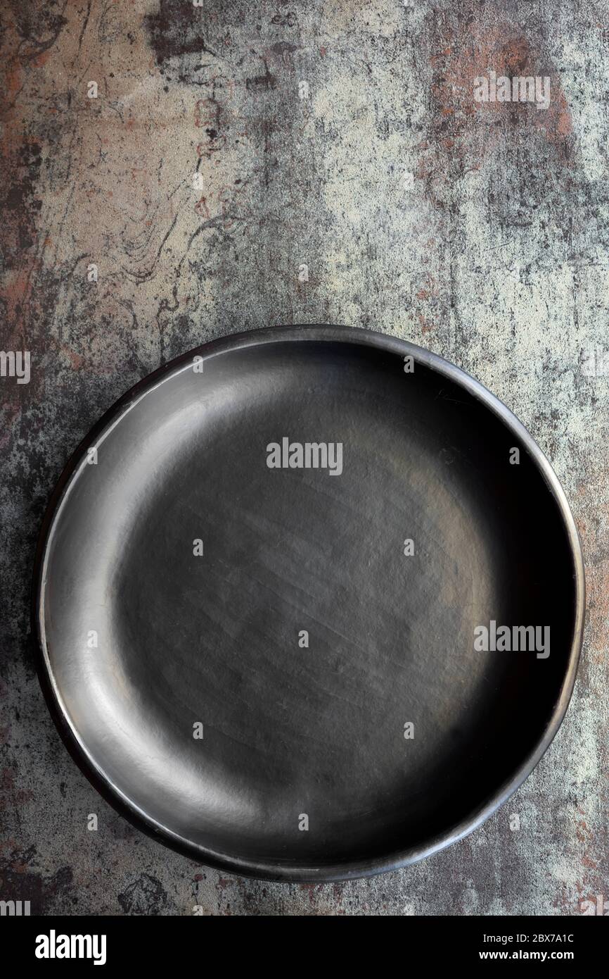 Empty rustic black plate on slate background, top view. Stock Photo