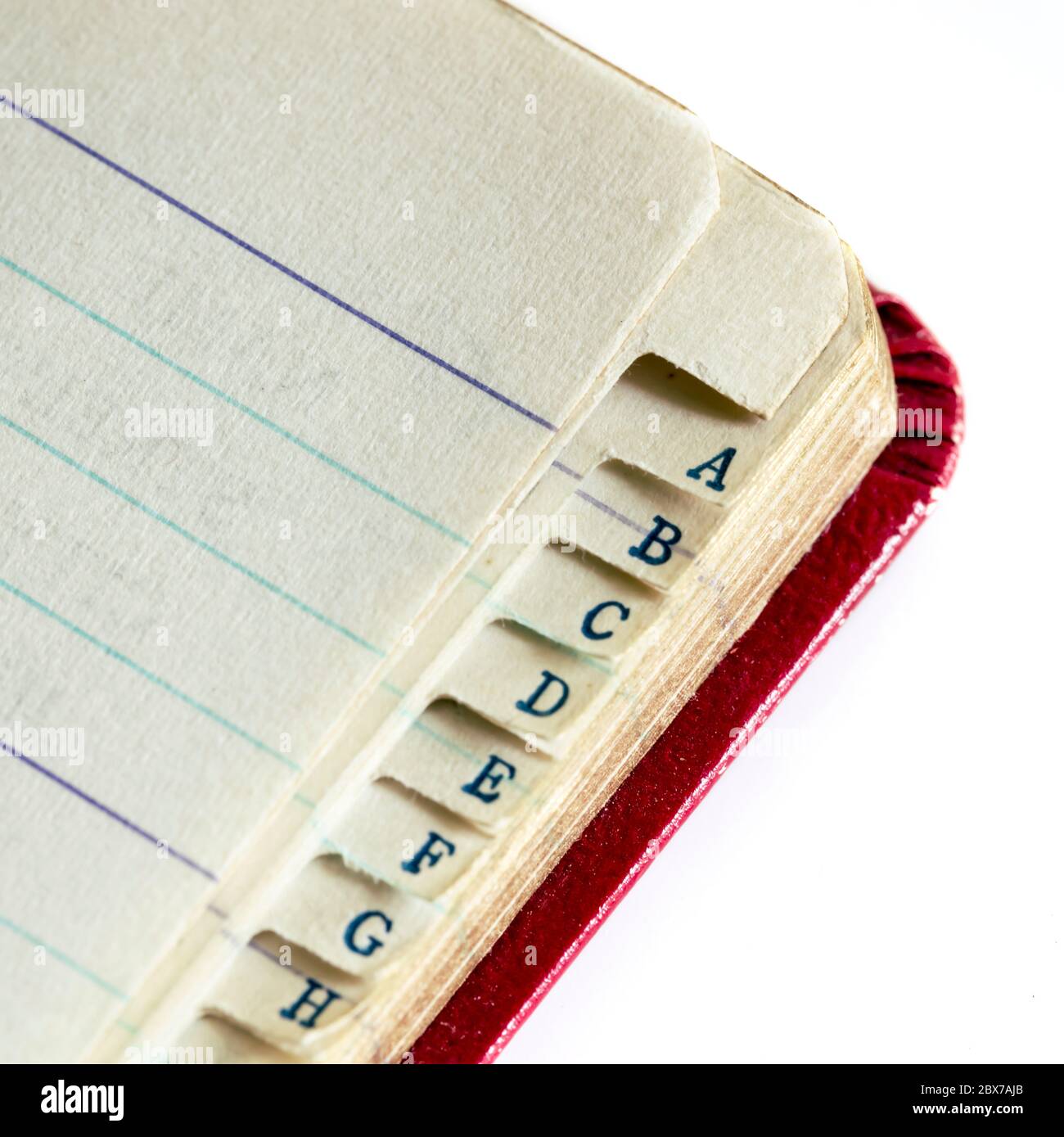 Vintage address book index in closeup over white background Stock Photo