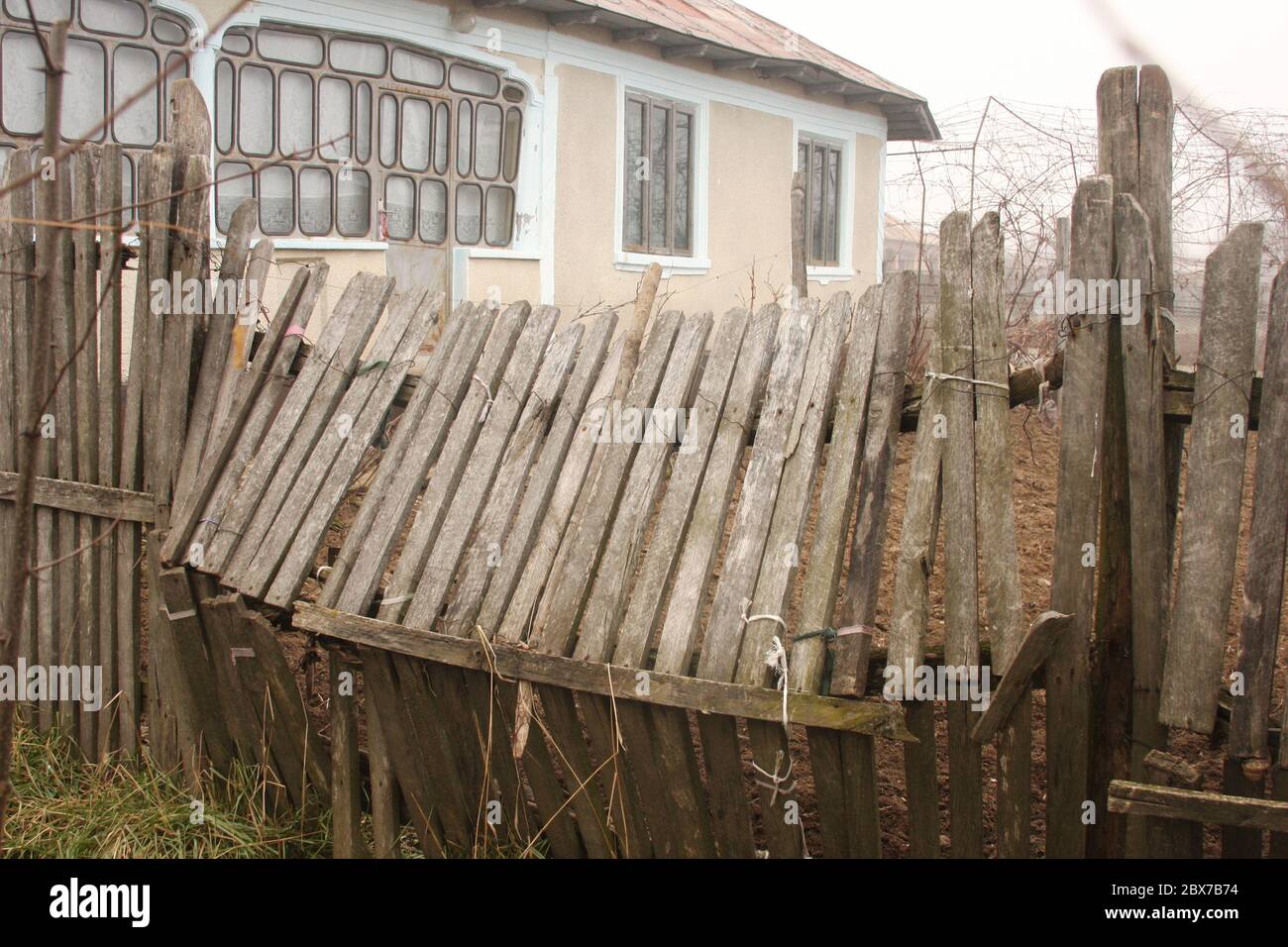 Broken wooden fence around a property in Silistea Gumesti, Romania Stock Photo