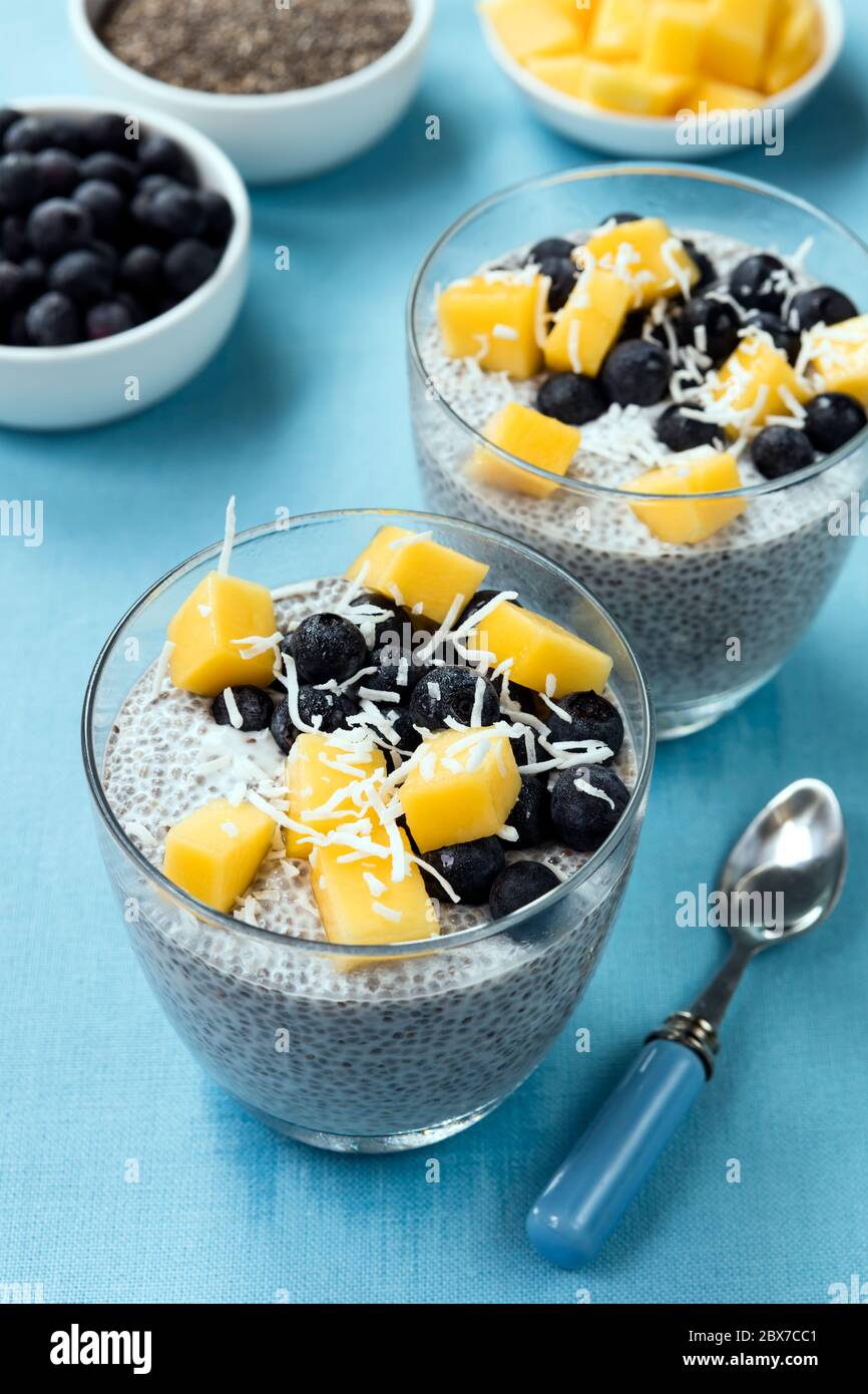 Chia seed pudding, with blueberries, mango and coconut. Vegan superfood with almond milk. Stock Photo