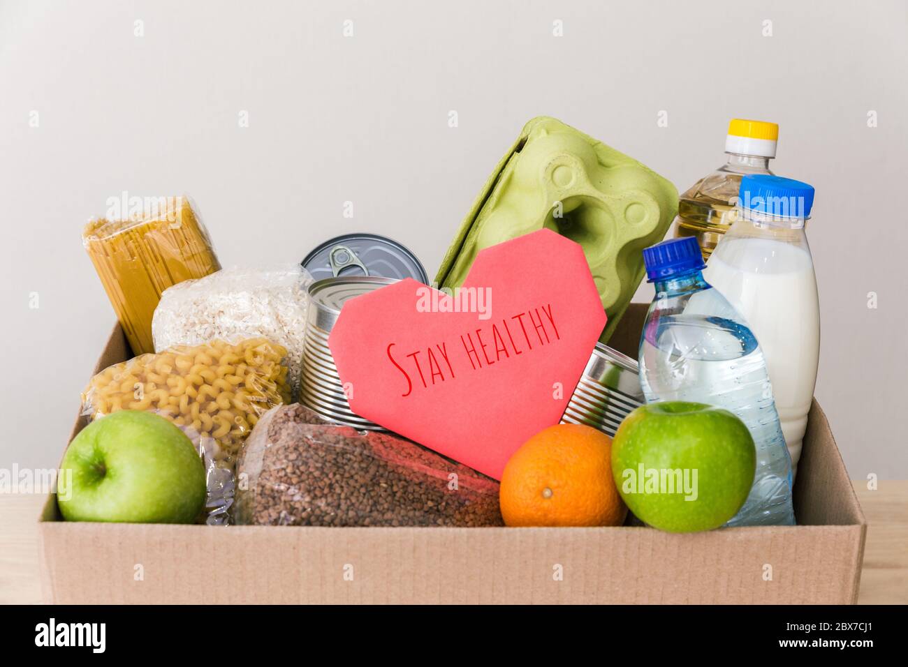 Charity donation box made of cardboard with food oil, fruits, cereals