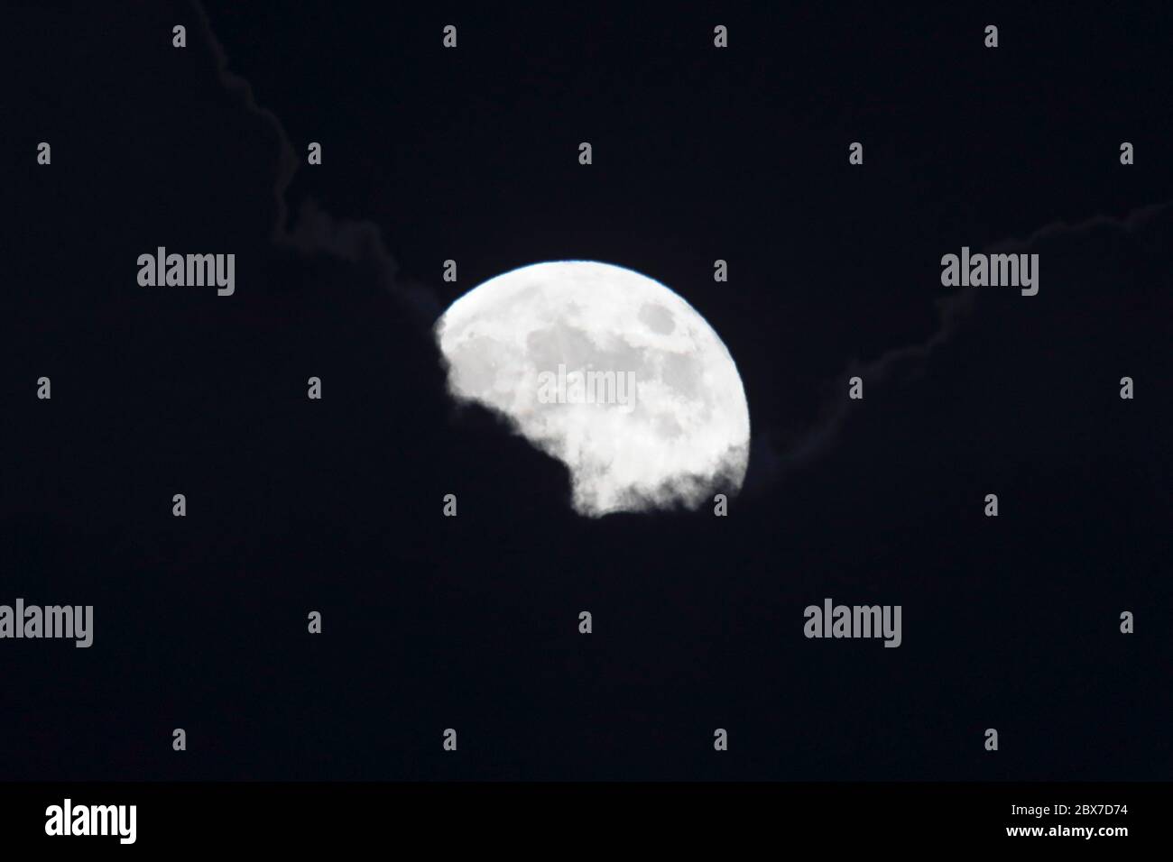 Hailsham, UK. 5th Jun 2020. UK weather. Tonights full moon, also known as a strawberry moon, rises behind clouds over Hailsham, East Sussex, UK. Credit: Ed Brown/Alamy Live News Stock Photo