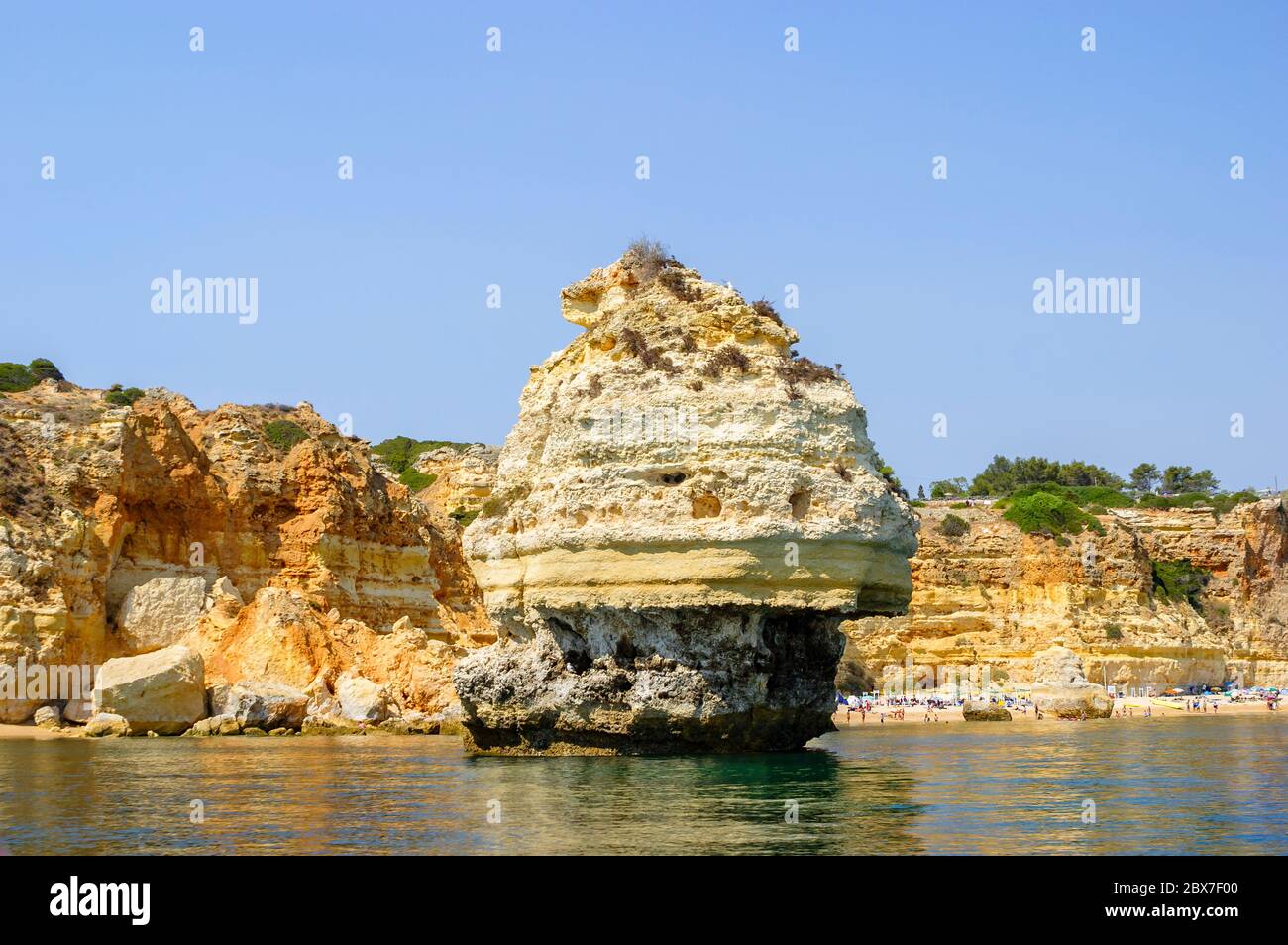 Praia do Torrado by Praia dos Caneiros, a picturesque beach with caves ...