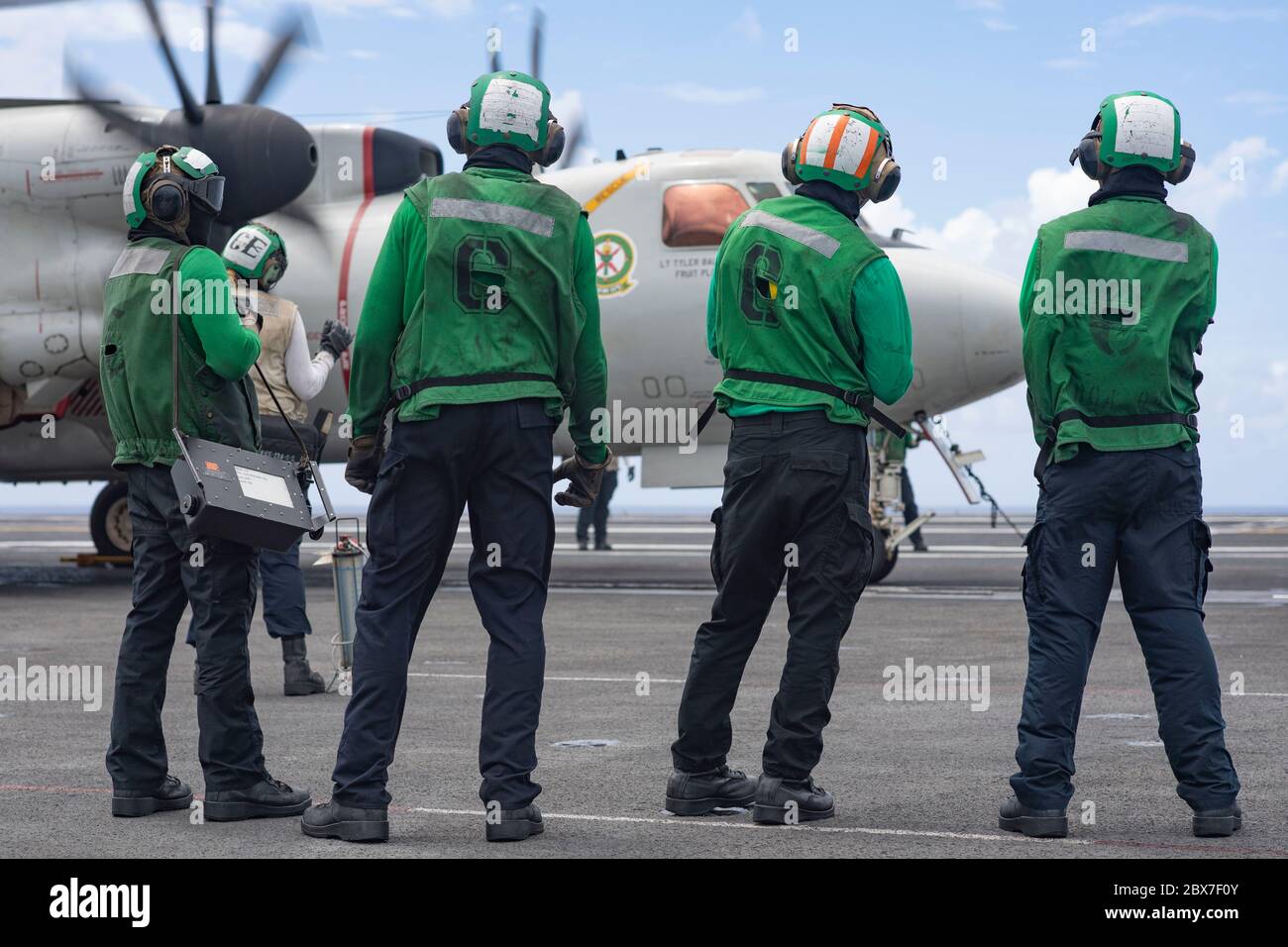 USS Theodore Roosevelt, United States. 05th June, 2020. U.S. Navy sailors prepare to launch an E-2C Hawkeye aircraft, assigned to the Liberty Bells of Airborne Command and Control Squadron 115, from the flight deck of the Nimitz-class aircraft carrier USS Theodore Roosevelt June 5, 2020 in the Philippine Sea. The ship is back on duty after a lengthy quarantine of COVID infected crew and is now continuing deployment to the 7th Fleet. Credit: MCS Dylan Lavin/U.S. Navy/Alamy Live News Stock Photo