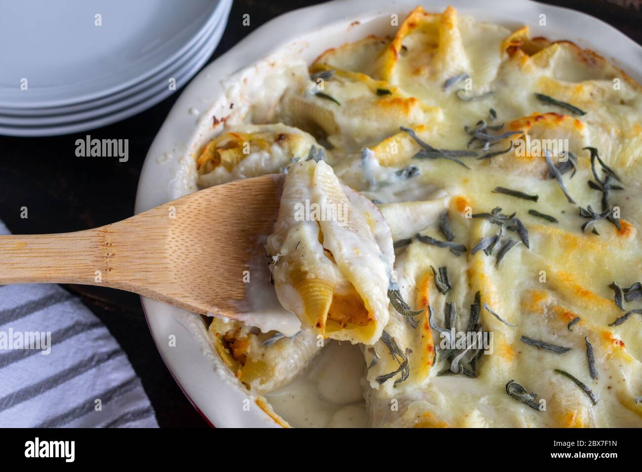 Butternut Squash Stuffed Shells: Jumbo pasta shells stuffed with butternut squash puree and topped with cream sauce, cheese, and sage leaves Stock Photo