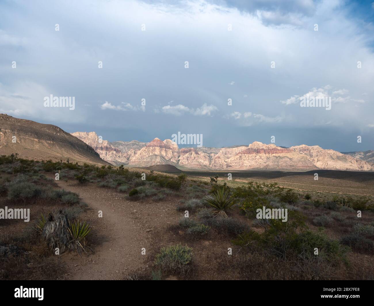 Hiking trail with a spring storm moving across Red Rock Canyon Stock Photo