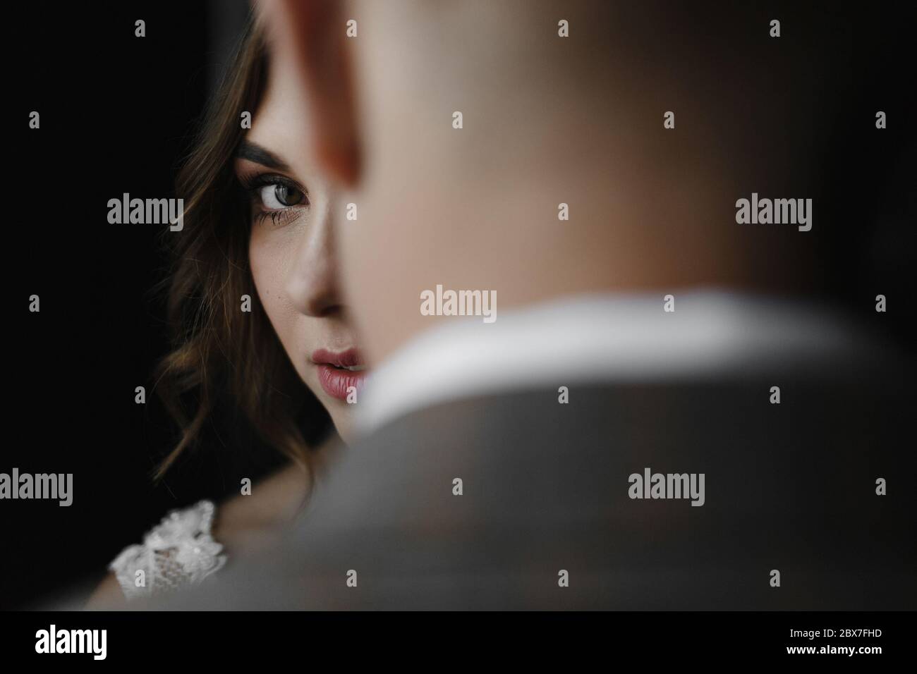 Bride looking over the groom. Bride and groom portrait Stock Photo