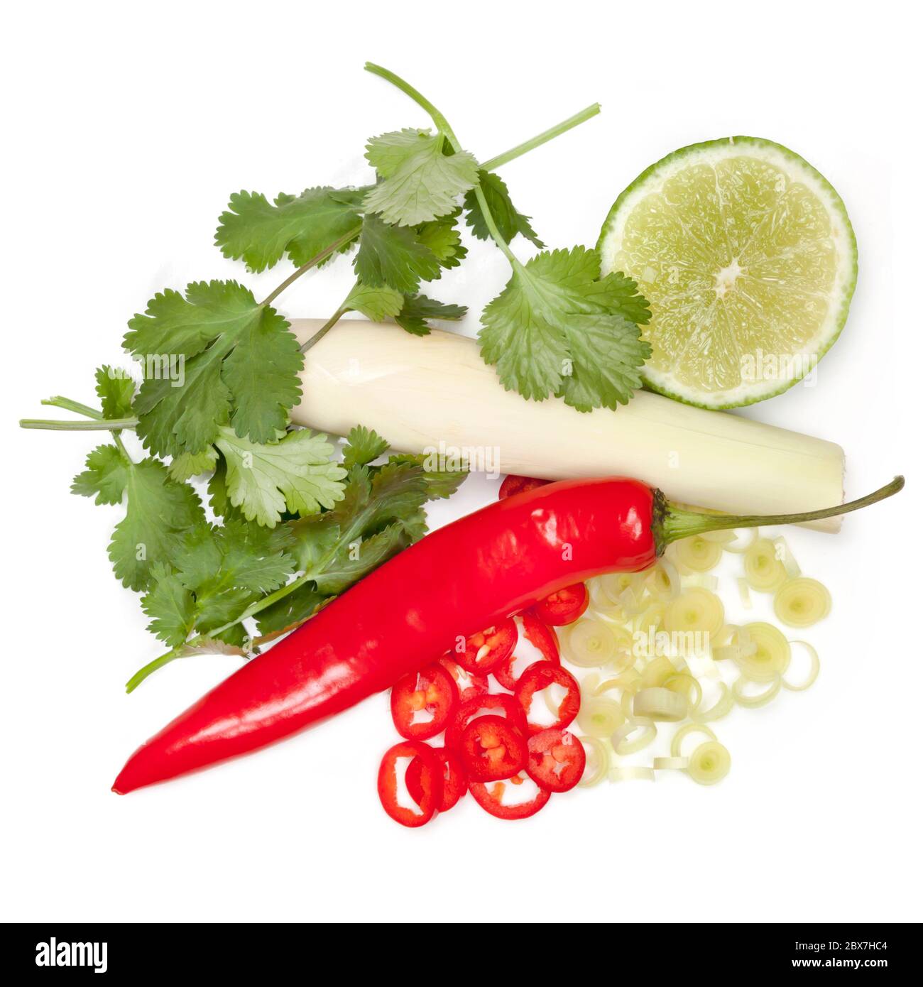 Thai food ingredients isolated. Lemongrass, coriander or cilantro, red chili and lime. Top view