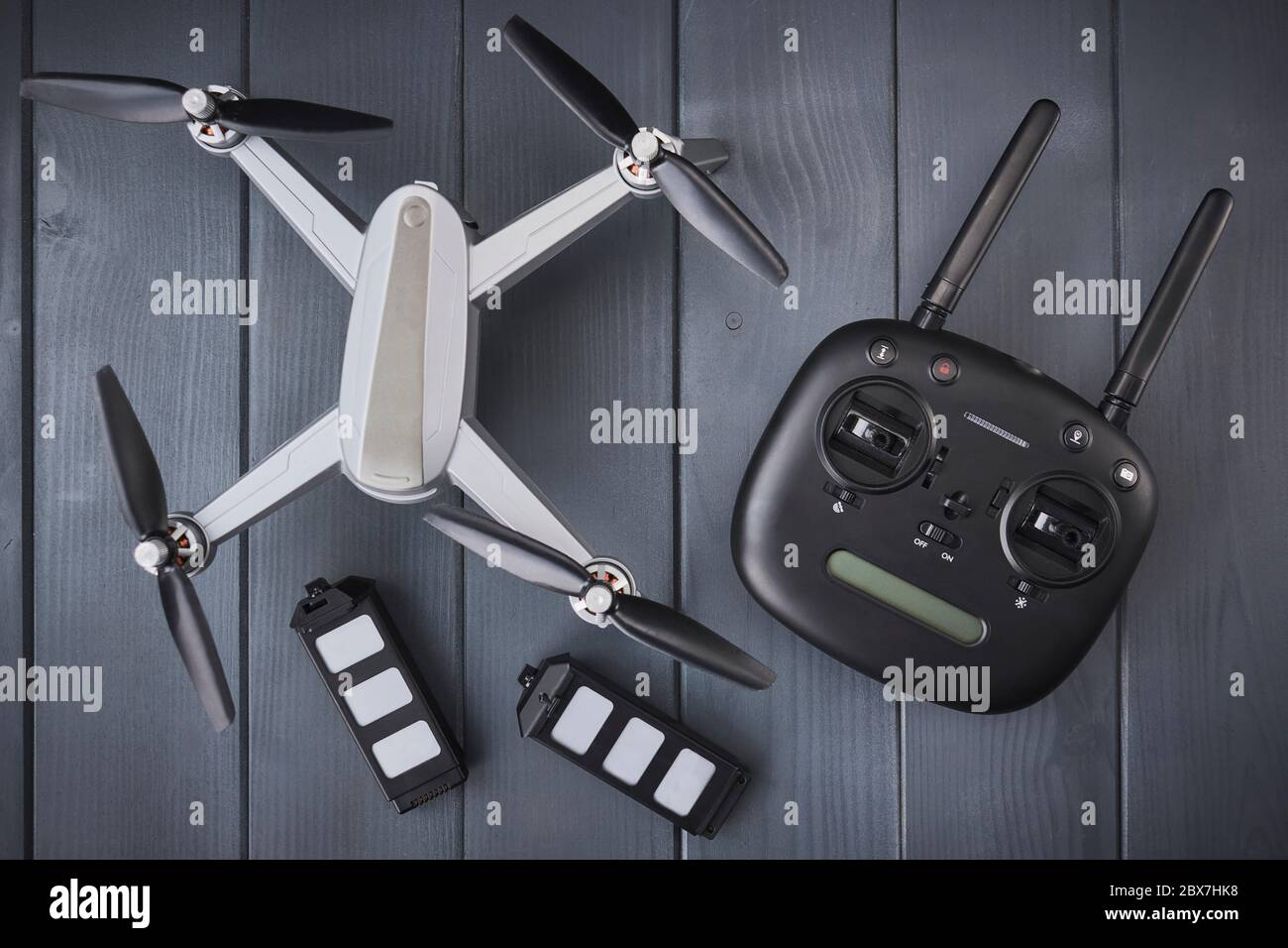 Quad-engine drone with high-resolution camera, batteries and radio control with dual frequency for capturing aerial images Stock Photo