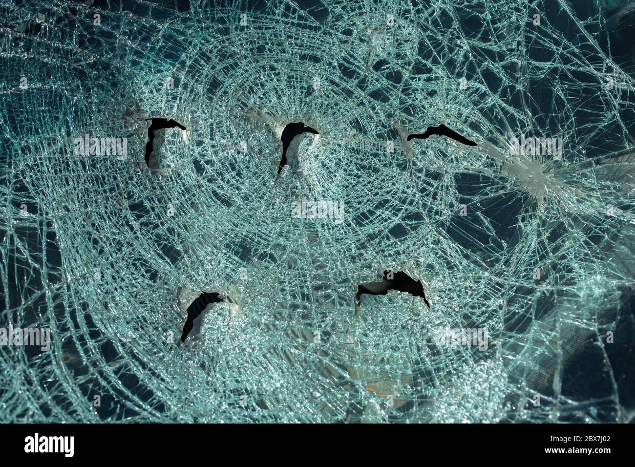 broken in a car accident car windshield with many cracks and holes Stock Photo