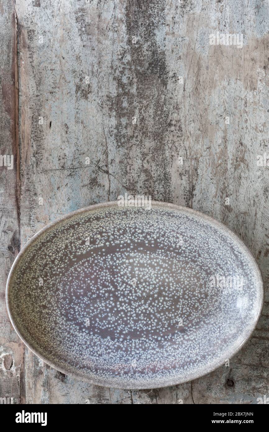Empty oval dish on rustic timber. Top view. Food background. Stock Photo