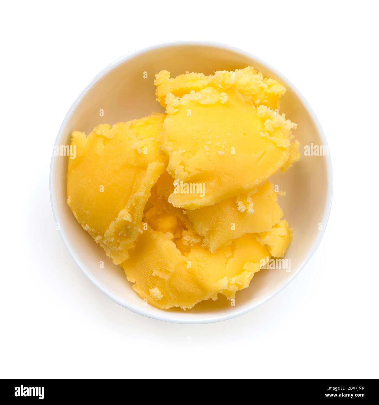 Ghee in dish, top view, isolated on white. Clarified butter Stock Photo