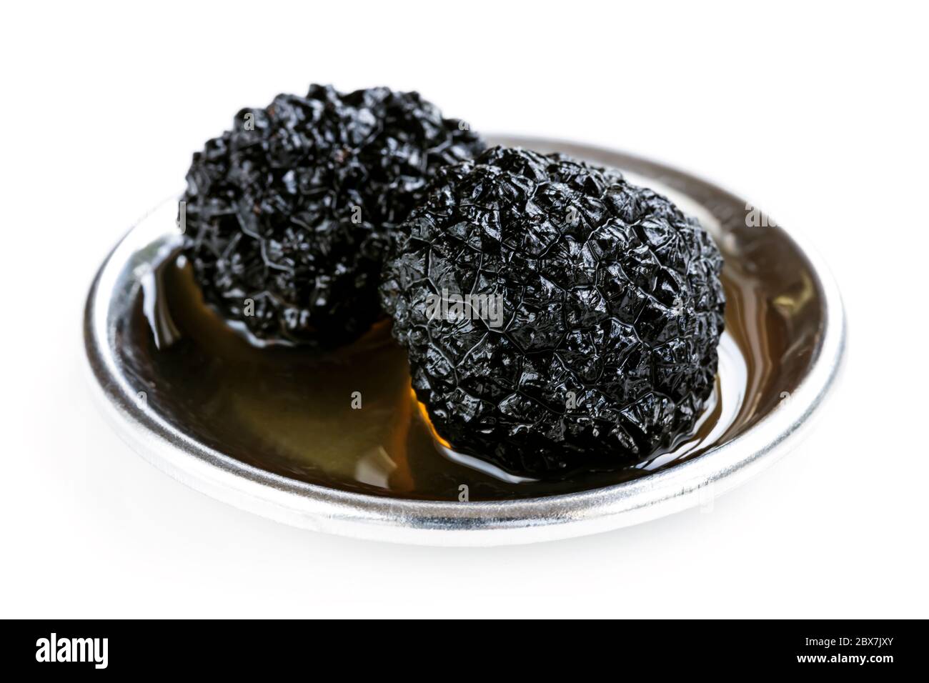 Black truffle mushrooms in oil, isolated on white Stock Photo Alamy