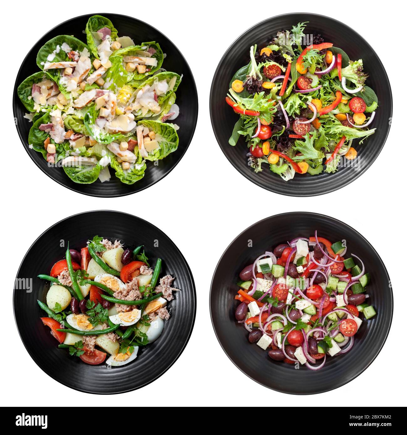 Set of different salads on white background.  Includes chicken caesar, garden, nicoise, and Greek. Stock Photo