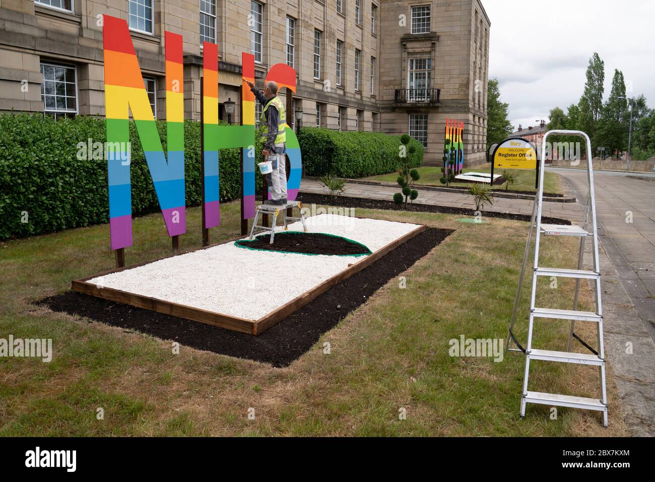 Bury, UK. 5th June, 2020. Picture shows an NHS sign being painted in raibow colours outside Bury Town Hall, Bury, UK. Credit: Jon Super/Alamy Stock Photo