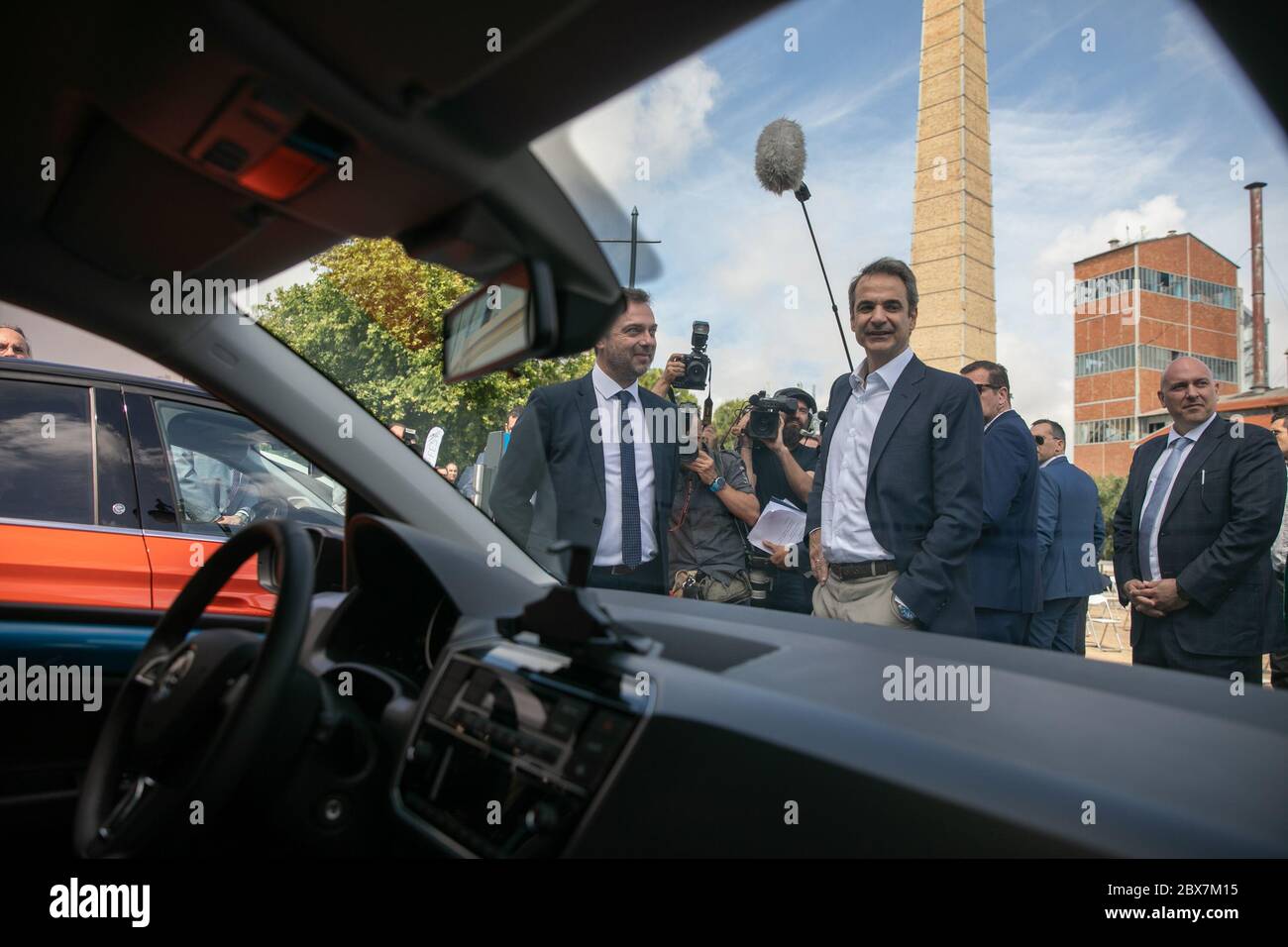 Athens, Greece. 5th June, 2020. Greek Prime Minister Kyriakos Mitsotakis (C) views new electric cars at a presentation event in Athens, Greece, on June 5, 2020. To mark World Environment Day on Friday, Greek Prime Minister Kyriakos Mitsotakis presented the government's plan for promoting electromobility, and the target is for one in three new vehicles in the country to be electric by 2030. Credit: Lefteris Partsalis/Xinhua/Alamy Live News Stock Photo