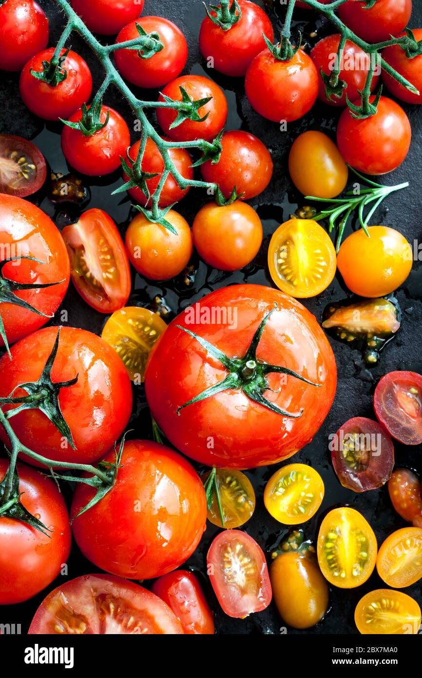 Tomato varieties on black iron. Overhead view Stock Photo Alamy