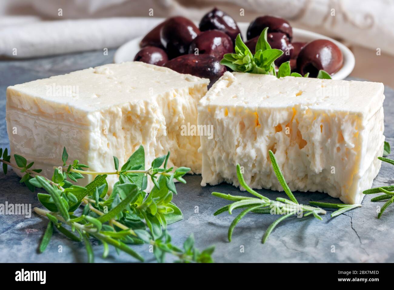 Goats cheese with black olives and herbs Stock Photo Alamy