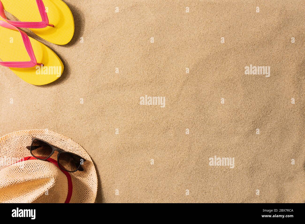 Summer vacation composition. Flip flops and straw hat on sand Stock ...