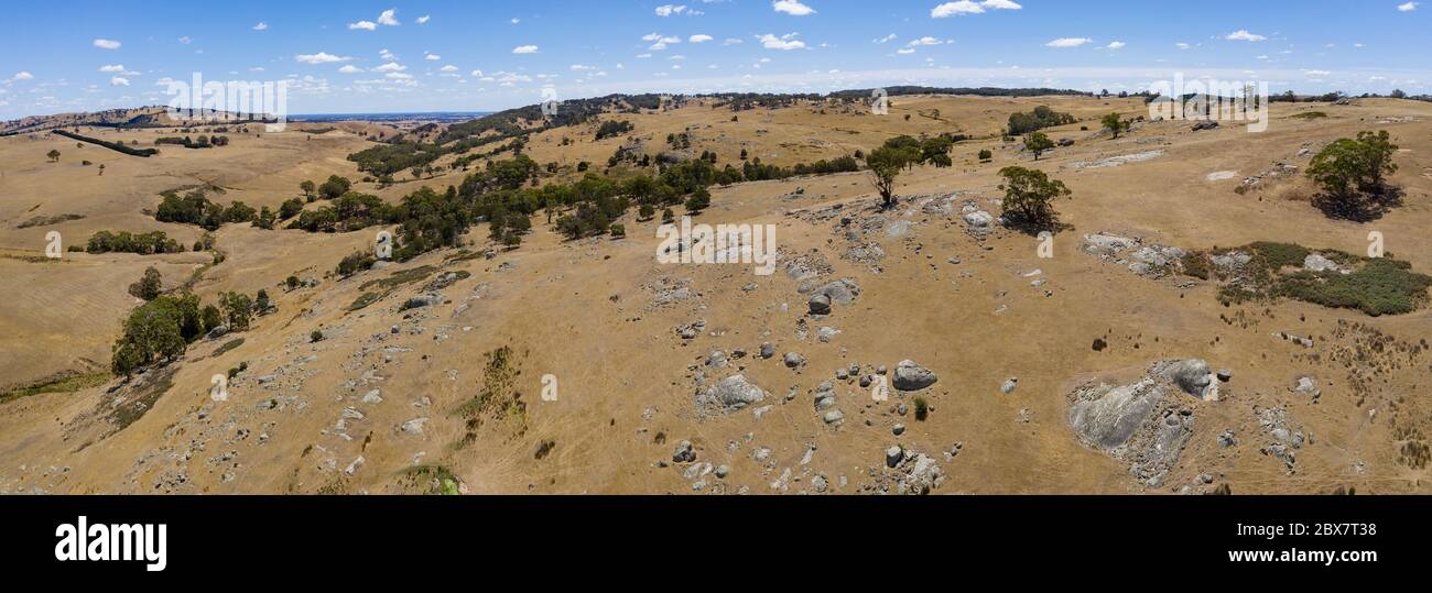 Aerial panoramic image of the dry bushland strewn with granite boulders near Lancefield in country Victoria, Australia Stock Photo