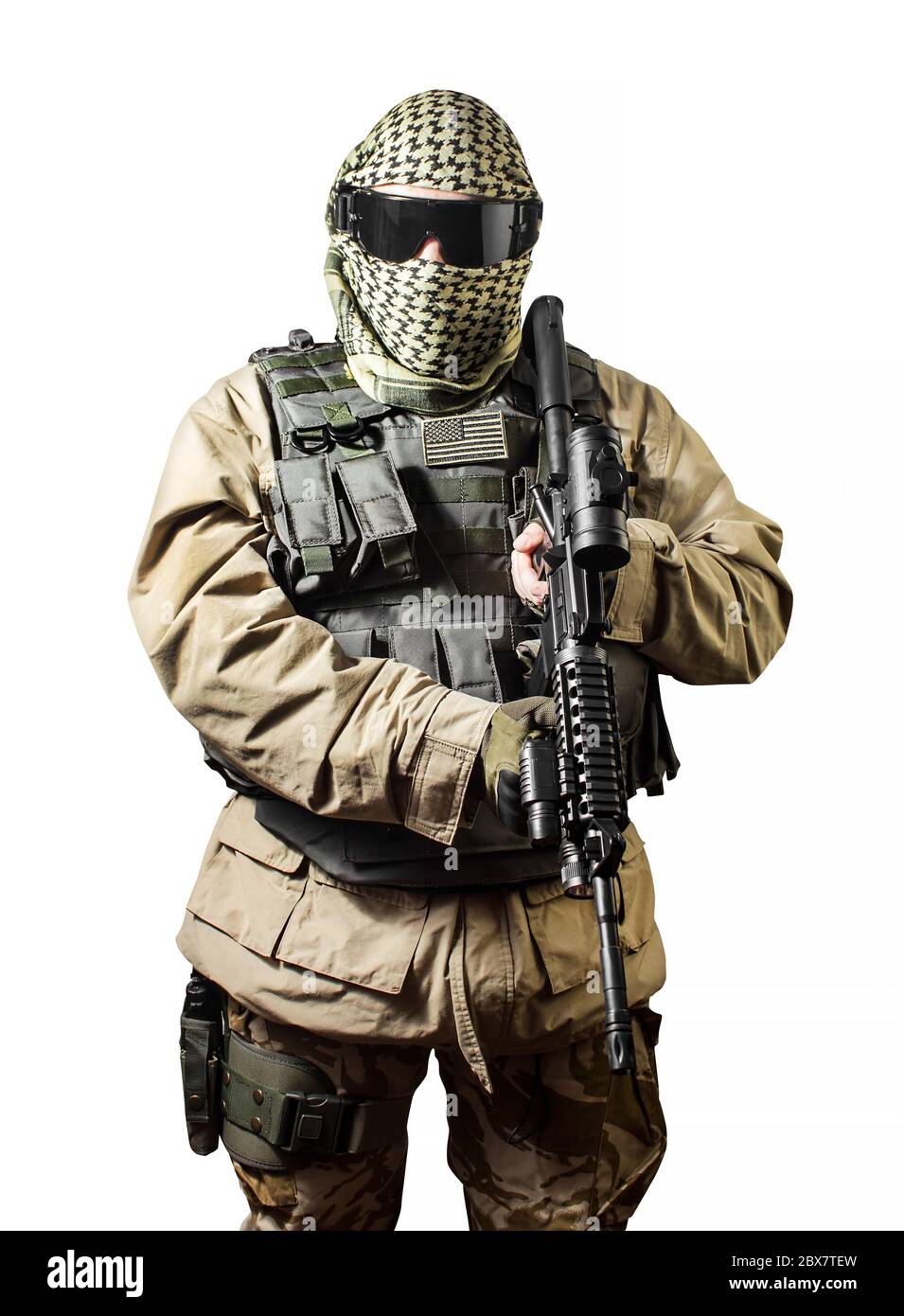 Isolated photo of a fully equipped military soldier standing with rifle and tactical glasses front view. Stock Photo