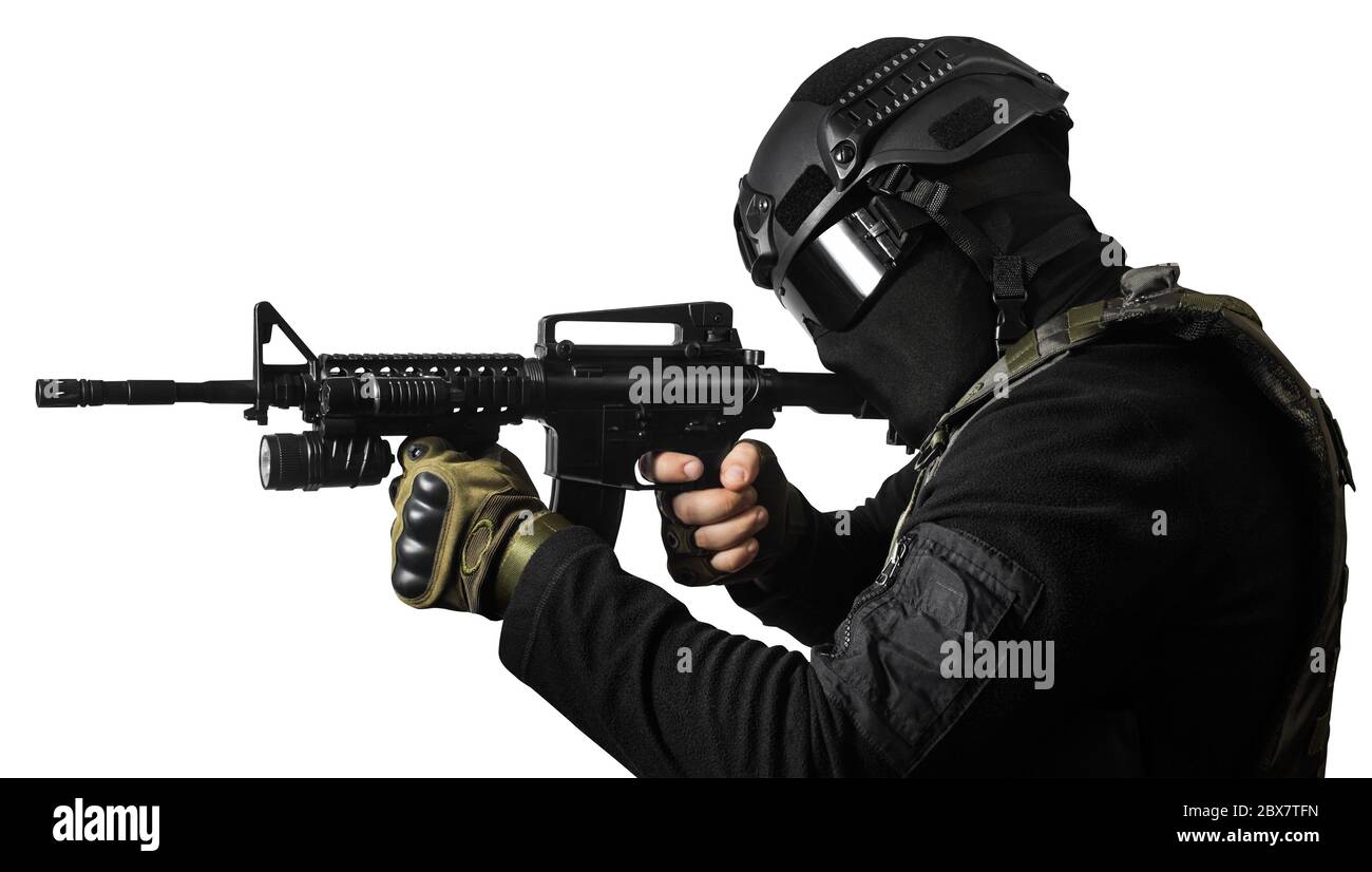 Isolated photo of a fully equipped swat soldier standing and aiming with rifle profile view. Stock Photo