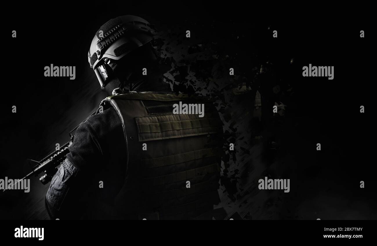 Black and white swat soldier back view posing with dissolving effect on black background. Stock Photo