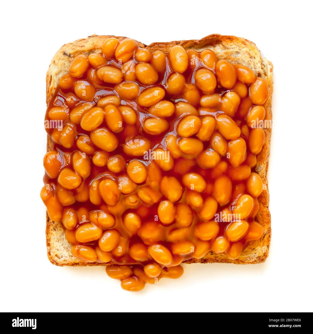 Baked beans on toast, isolated on white background.  Overhead view. Stock Photo