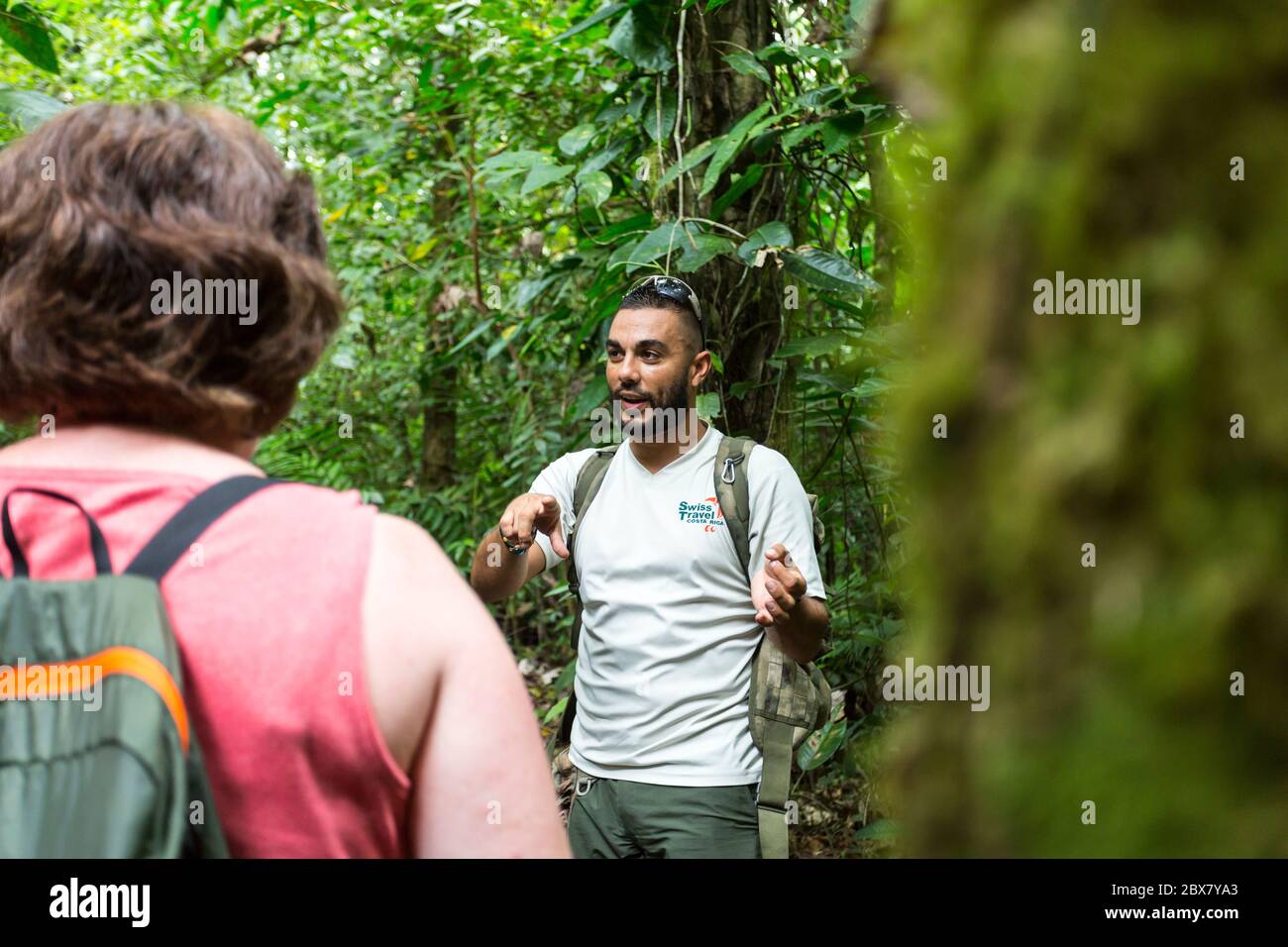 Alan, tour guide with Swiss Travel communicates with hikers in Sensoria, tropical rainforest reserve, Rincon de la Vieja, Provincia de Alajuela, Costa Stock Photo