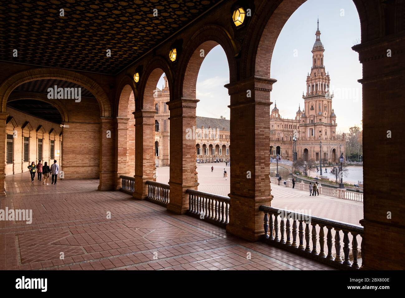 Seville, Spain – 2019. People walking down a street in the old city ...