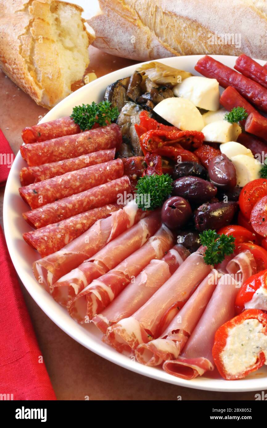 Platter of antipasti appetizers, with crusty bread Stock Photo Alamy