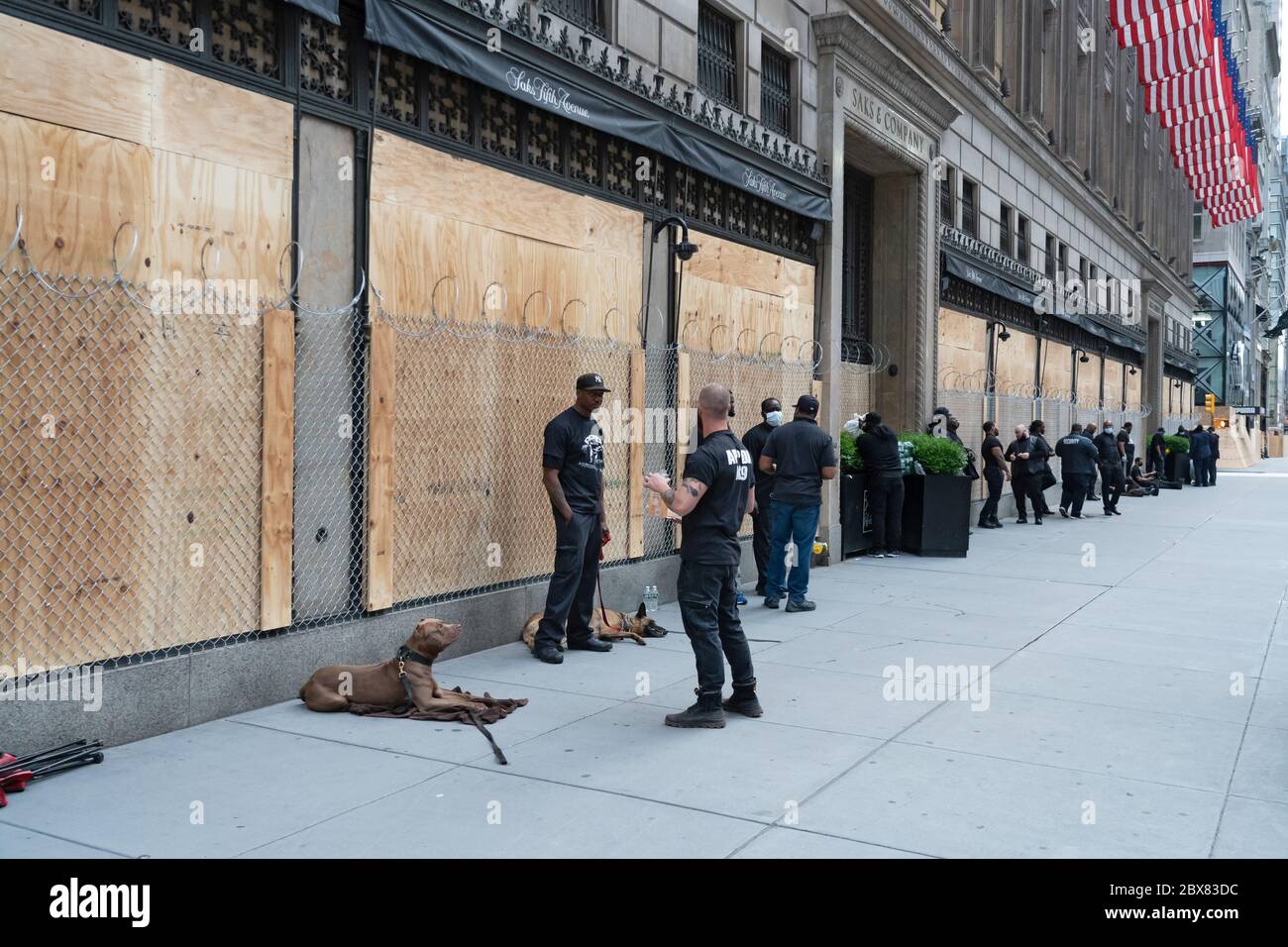 NEW YORK, NY - JUNE 03: Famed Saks Fifth Avenue prepare for more looting with with chain link fence over the boarded windows and security guards and d Stock Photo