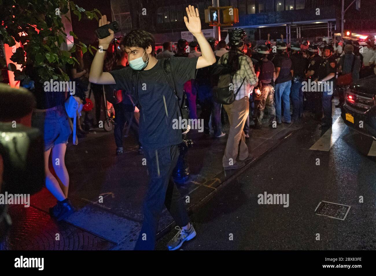 NEW YORK, NY - JUNE 03: Protester walking away with his hands raise as police make dozens of arrests during demonstrations in Manhattan over the killi Stock Photo