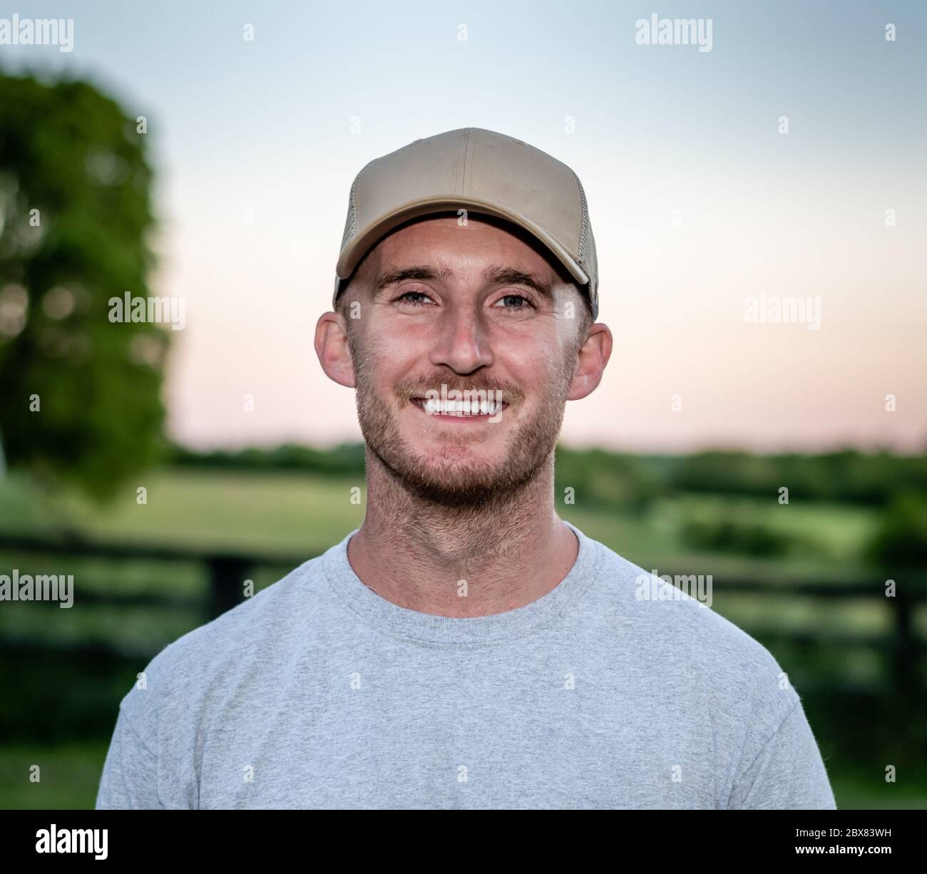 Caucasian man wearing hat/cap smiling in front of fence in Kentucky Stock  Photo - Alamy