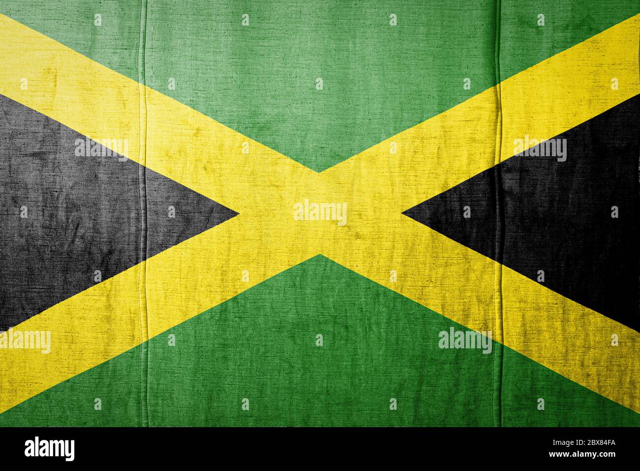 National flag of Jamaica depicting in paint colors on old textile. Flag