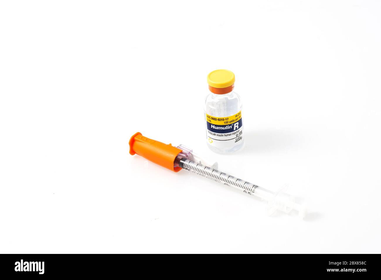 Portland, OR May 17 2020. A vial of  Humulin R insulin,  an essential diabetes drug, and a special insulin syringe on a white background. Stock Photo