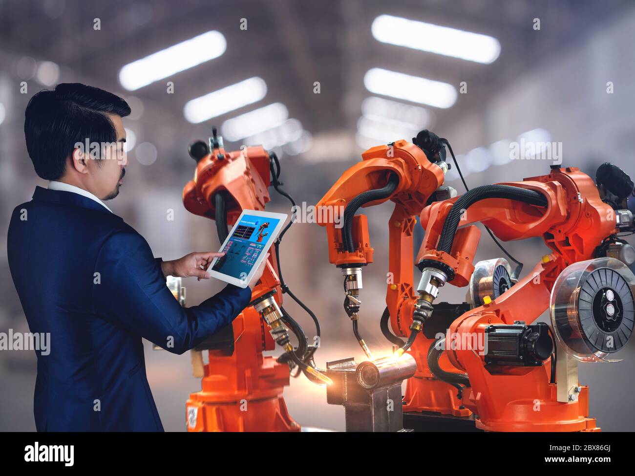 The robot arms is used for arc welding industry,Technical engineer are control robotics features high repeat positioning accuracy,for quality welding Stock Photo