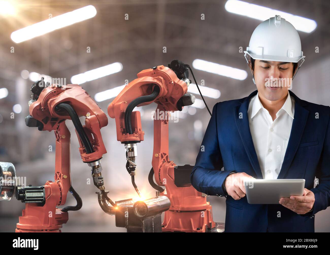 The robot arms is used for arc welding industry,Technical engineer are control robotics features high repeat positioning accuracy,for quality welding Stock Photo