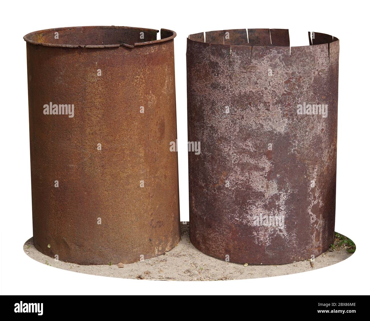 Rusty iron barrels stand on the ground near a village shed. Isolated Stock Photo