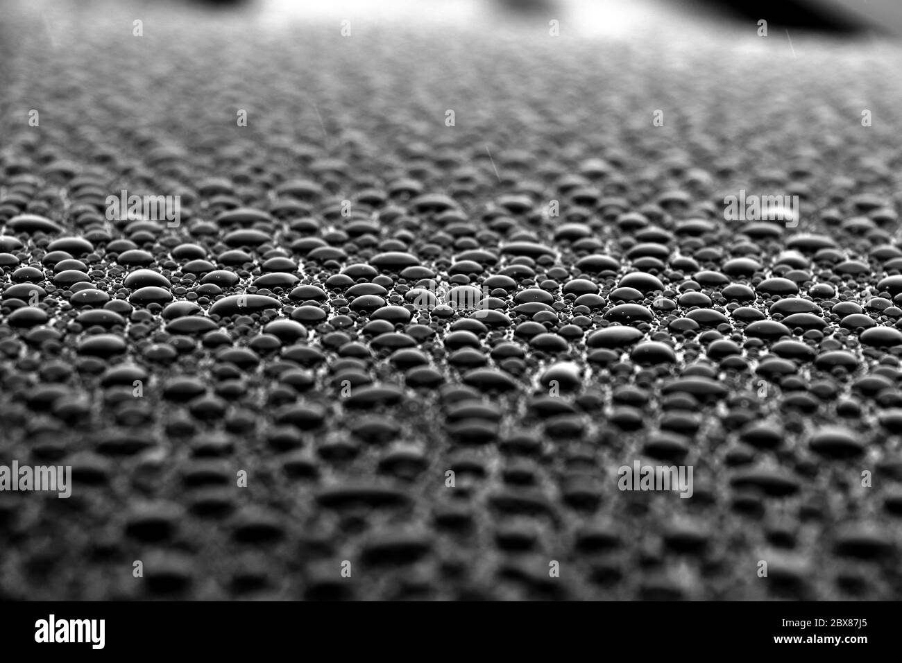 Close up of thousands of beaded water droplets on auto vehicle Stock Photo