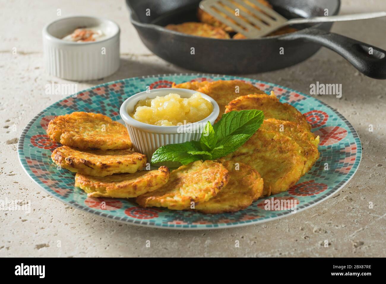 Latkes with apple sauce. Fried potato pancakes. Stock Photo