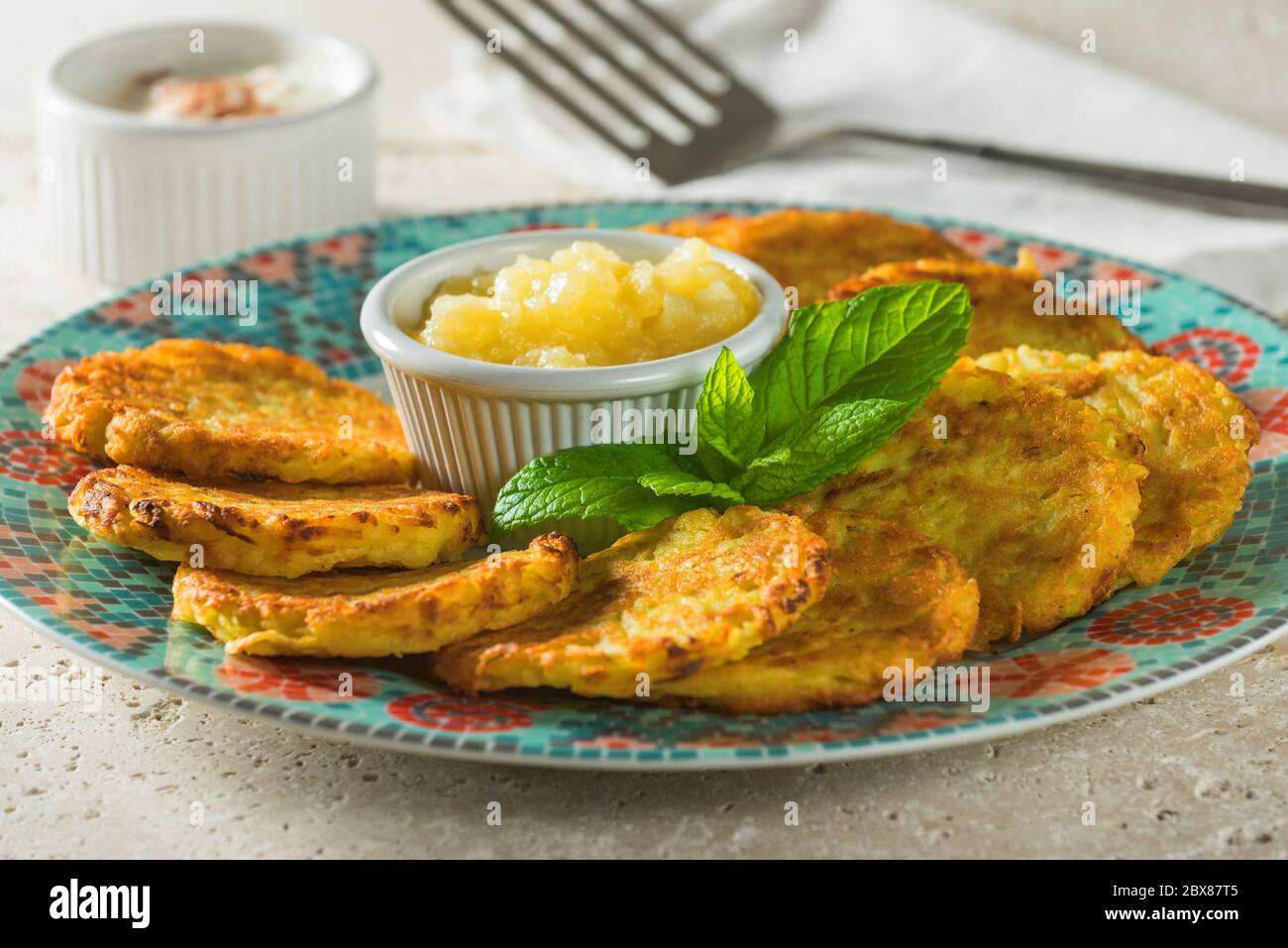 Latkes with apple sauce. Fried potato pancakes. Stock Photo