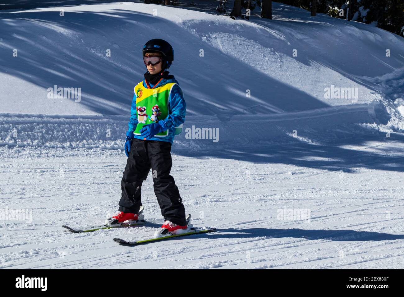 Sureanu Ski Resort, Romania - Child skiing in mountains. Ski race for young children. Winter sport for family. Kids ski lesson in alpin school Stock Photo