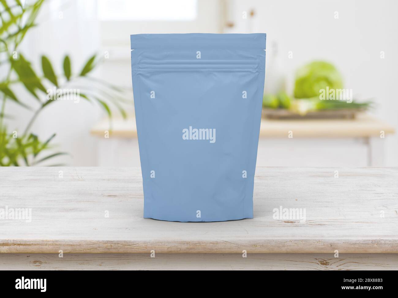 The blue food and snack pouch bag packaging mock-up design front view on wooden table Stock Photo