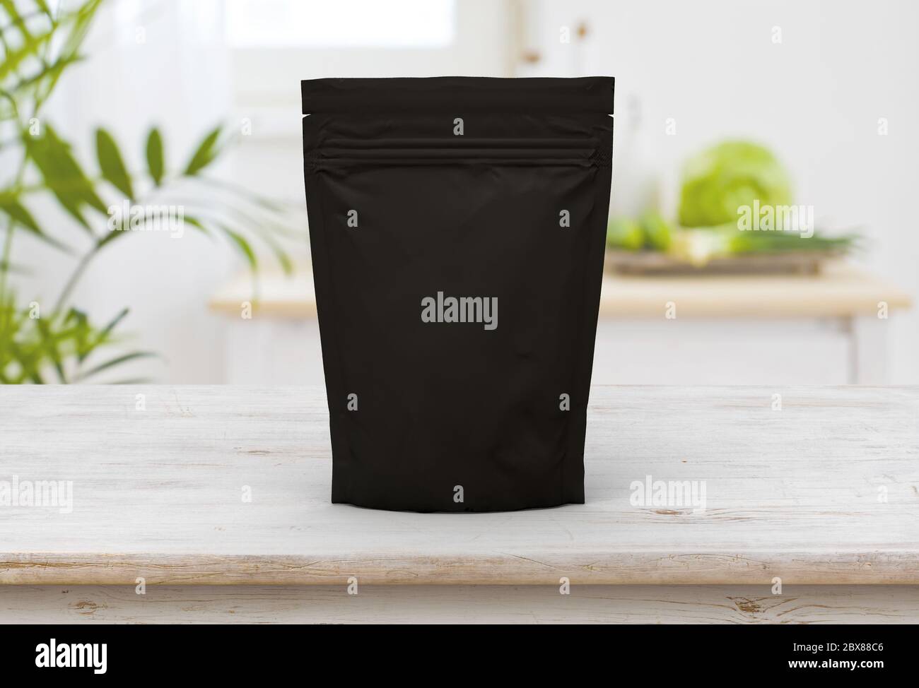 The black food and snack pouch bag packaging mock-up design front view on wooden table Stock Photo
